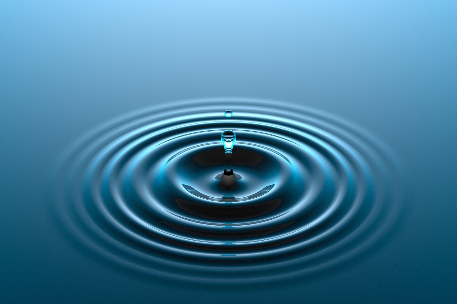 Water drop falling into water surface